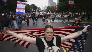 Demonstrators march down Benjamin Franklin Parkway during the "No Kings" protest, Saturday, June 14, 2025, in Philadelphia.