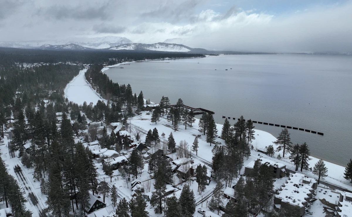 In an aerial view, snow covers the banks of Lake Tahoe on March 21, 2023 in South Lake Tahoe, California.