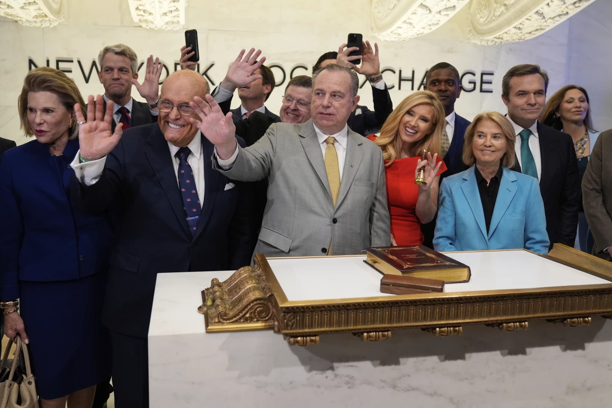 Newsmax CEO Christopher Ruddy, center, and former New York Mayor Rudy Giuliani, center left, celebrate the conservative network's initial public offering on the floor of the New York Stock Exchange on April 3.
