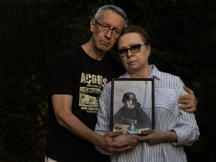 Andriy Kuvshynov and Iryna Mamaysur hold a portrait of their daughter, Oleksandra Kuvshynova, in 2024.