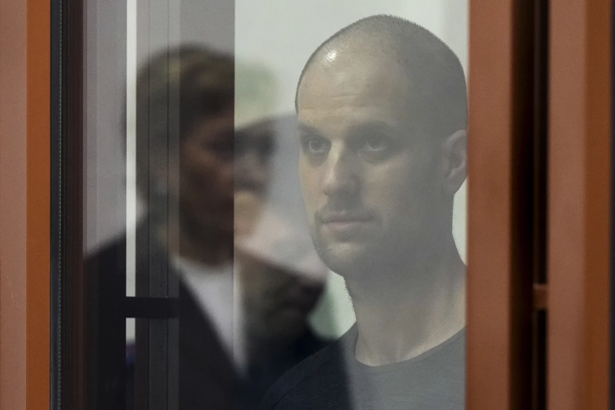 Evan Gershkovich, accused of espionage, looks out from inside a glass defendants' cage prior to a hearing in Yekaterinburg's Sverdlovsk Regional Court on June 26.