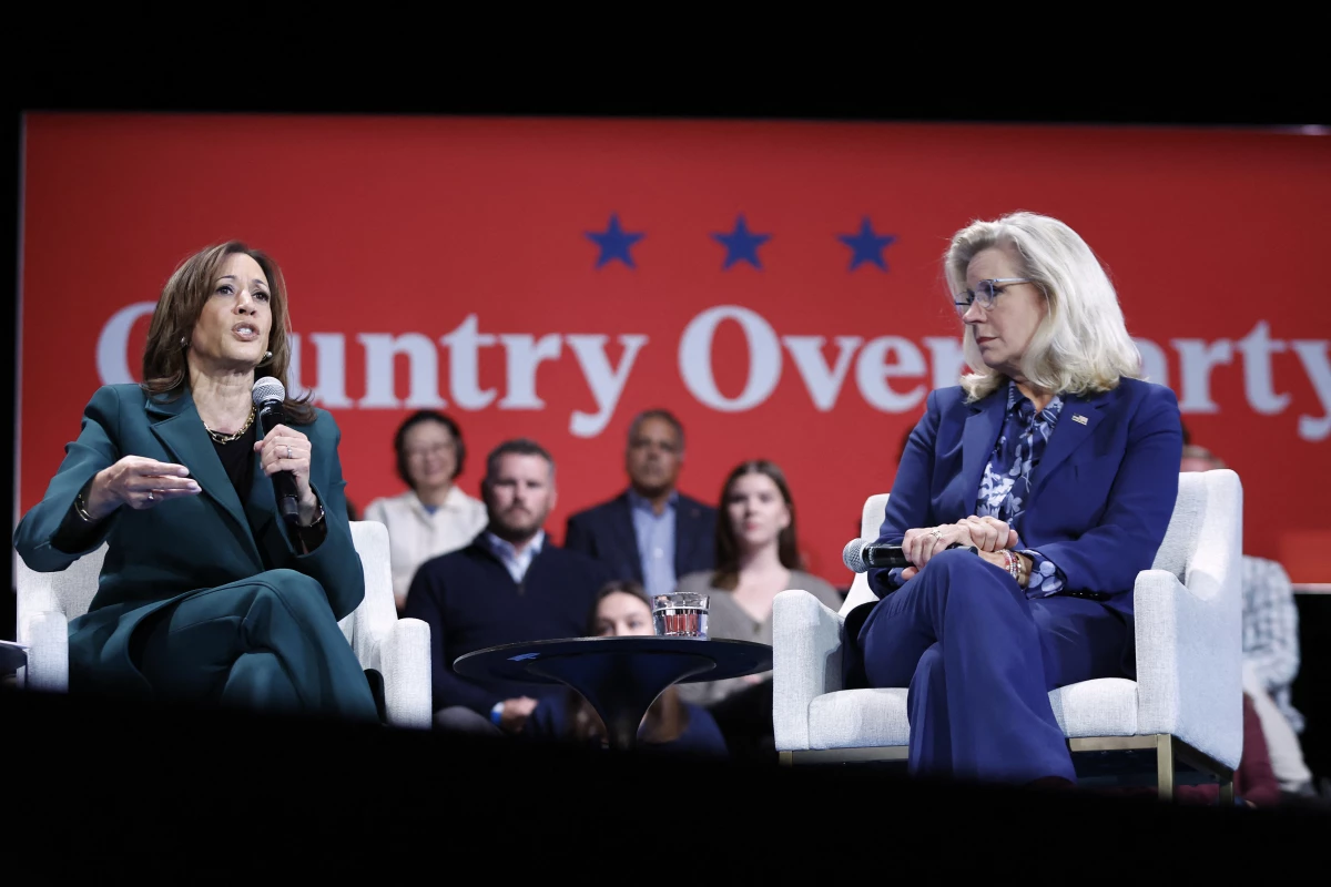 Vice President Harris speaks during a moderated conversation with former Rep. Liz Cheney in Brookfield, Wisc., on Monday. They spoke in front of a banner reading 'Country Over Party.'