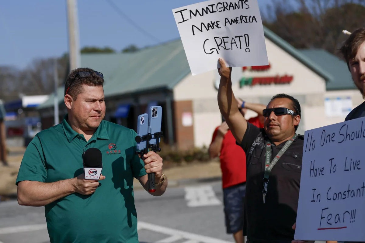 Mario Guevara, the metro Atlanta-based Spanish-language reporter, covers a protest against immigration enforcement on Buford Highway, Ga., on Saturday, Feb. 1.