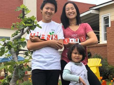 Jinghuan Liu Tervalon, her son, Samuel Smookler, and daughter, Colette Liu Tervalon, in front of the family home in Altadena.