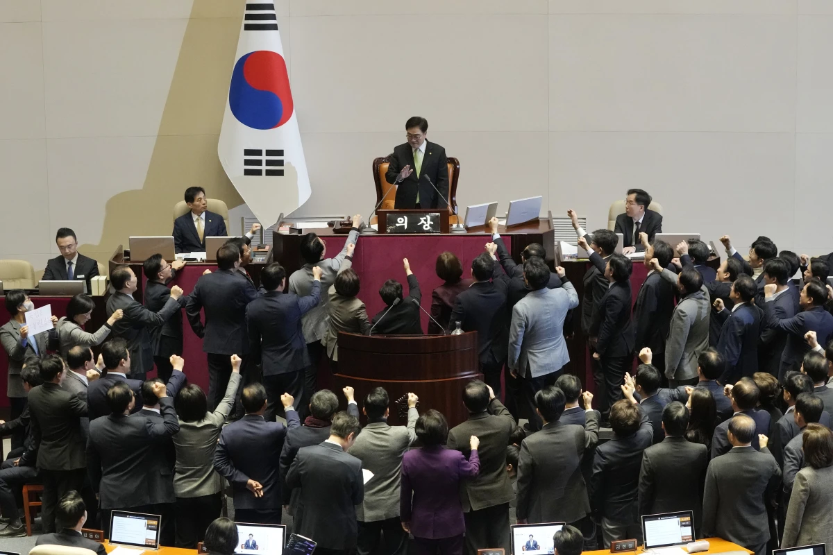 Lawmakers of the ruling People Power Party protest to South Korea's National Assembly Speaker Woo Won Shik, top center, during a plenary session for the impeachment motion against South Korean acting President Han Duck-soo at the National Assembly in Seoul, South Korea, Friday Dec. 27, 2024.