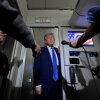 President Donald Trump talks to reporters on board Air Force One on Monday.