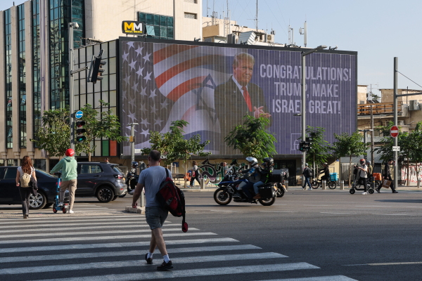 Cars drive past a large billboard congratulating US Republican presidential candidate and former president Donald Trump at a traffic junction in Israel's coastal city of Tel Aviv on Wednesday.