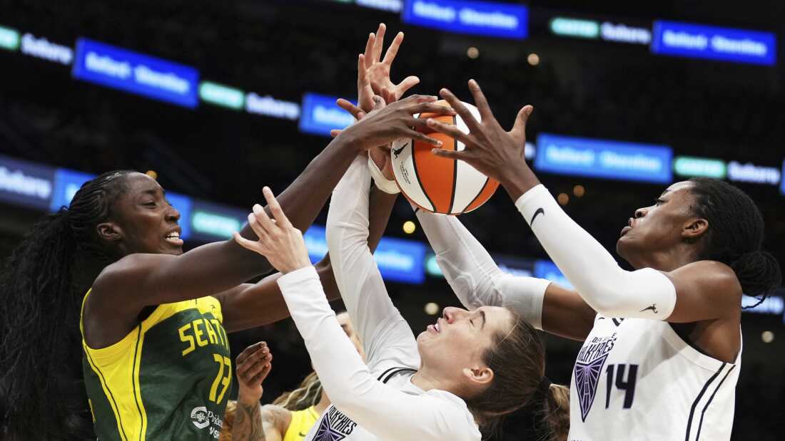 Golden State Valkyries guard Kate Martin (20) struggles to maintain possession against Seattle Storm forward Ezi Magbegor (left) as Valkyries center Temi Fagbenle (14) reaches for the ball during the second half of a WNBA game Wednesday in Seattle. The Valkyries debuted this season as the league's 13th team.