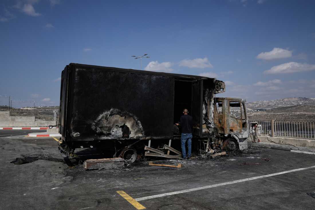 A Palestinian man surveys damage in an industrial zone following an attack by Israeli settlers the previous day in the West Bank village of Beit Lid, near Tulkarm, Wednesday.