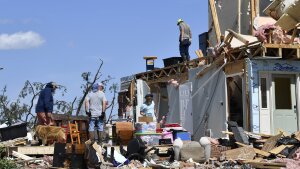 Family members cull through the debris of their home that was destroyed by a severe storm in London, Ky., on Saturday.