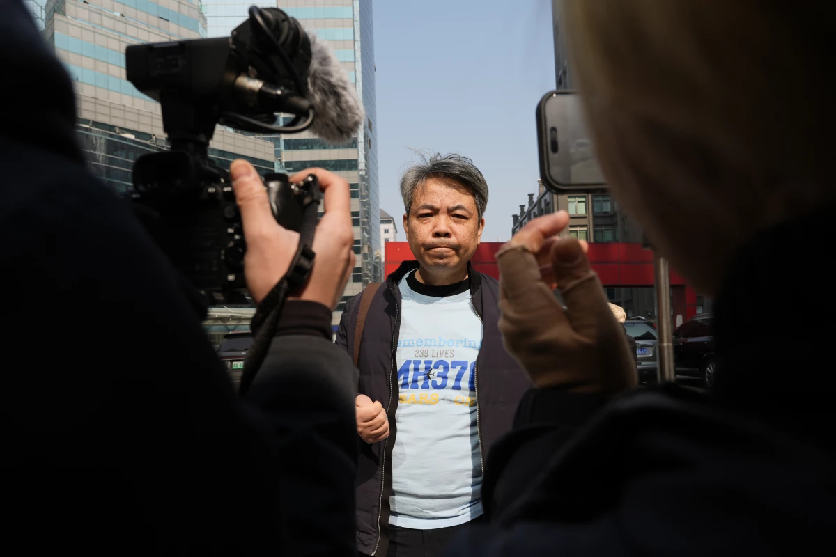 Jiang Hui, whose mother was on the missing MH370 Malaysia Airlines passenger jet, wears a shirt 'Remembering 239 Lives, MH370' as he talks to media on the 11th anniversary of the jet going missing on March 8, 2025, in Beijing, China.