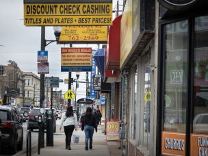 People walk along 26th Street, the heart of the commercial district in the Little Village neighborhood in Chicago, a neighborhood predominantly composed of Mexican immigrants.