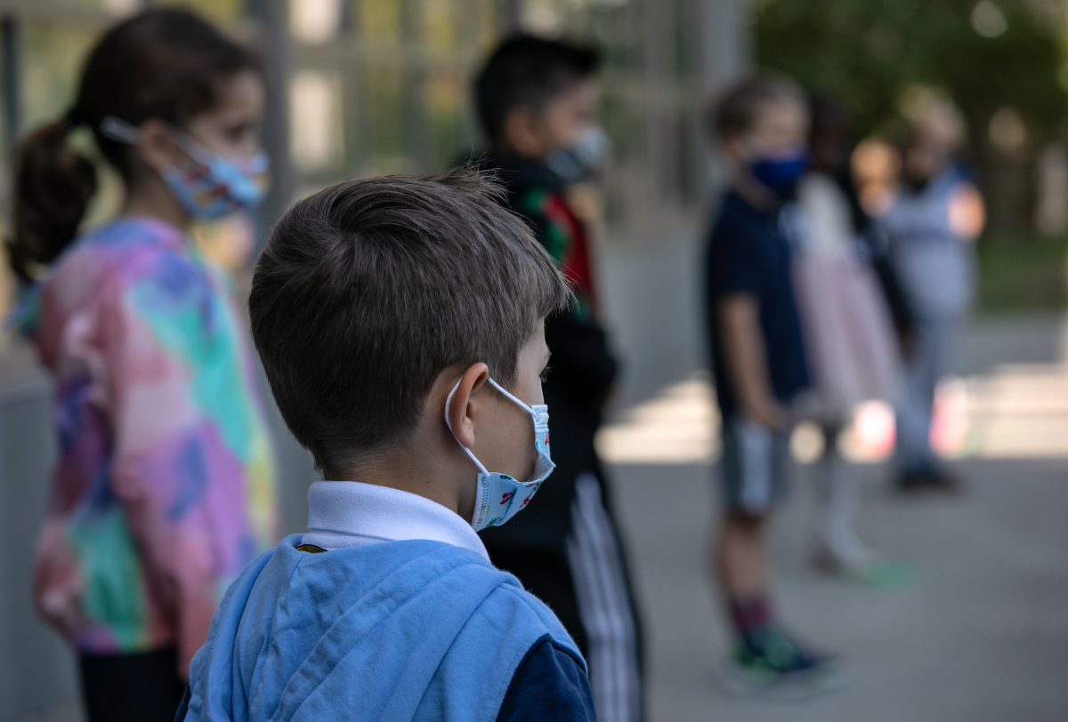 Masked school children wait to have their portraits taken during picture day at Rogers International School on September 23, 2020 in Stamford, Connecticut.