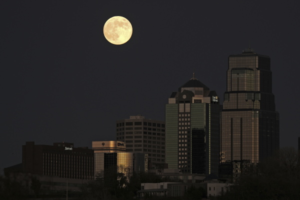 The supermoon rises beyond the downtown buildings Friday, Nov. 15, 2024, in Kansas City, Mo.