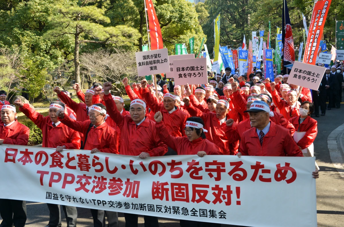 Akira Banzai (center), chief of Japan's farmers association, and their members gesture as they protest against the Trans-Pacific Partnership (TPP) free trade talks at a rally in Tokyo on March 12, 2013, when then-Prime Minister Shinzo Abe was expected to announce he would join TPP negotiations that week.