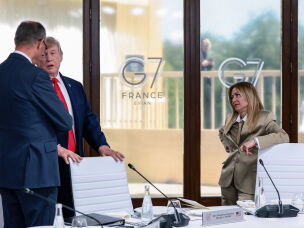 President Donald Trump speaks with German Chancellor Friedrich Merz as Italian Prime Minister Giorgia Meloni looks on at the G7 meeting in Evian, France, on June 16.