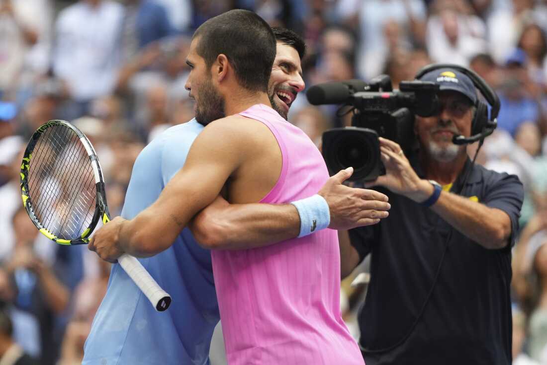 Novak Djokovic, of Serbia, hugs Carlos Alcaraz, of Spain, after losing to Alcaraz in the men's singles semifinals of the U.S. Open tennis championships, on Friday.