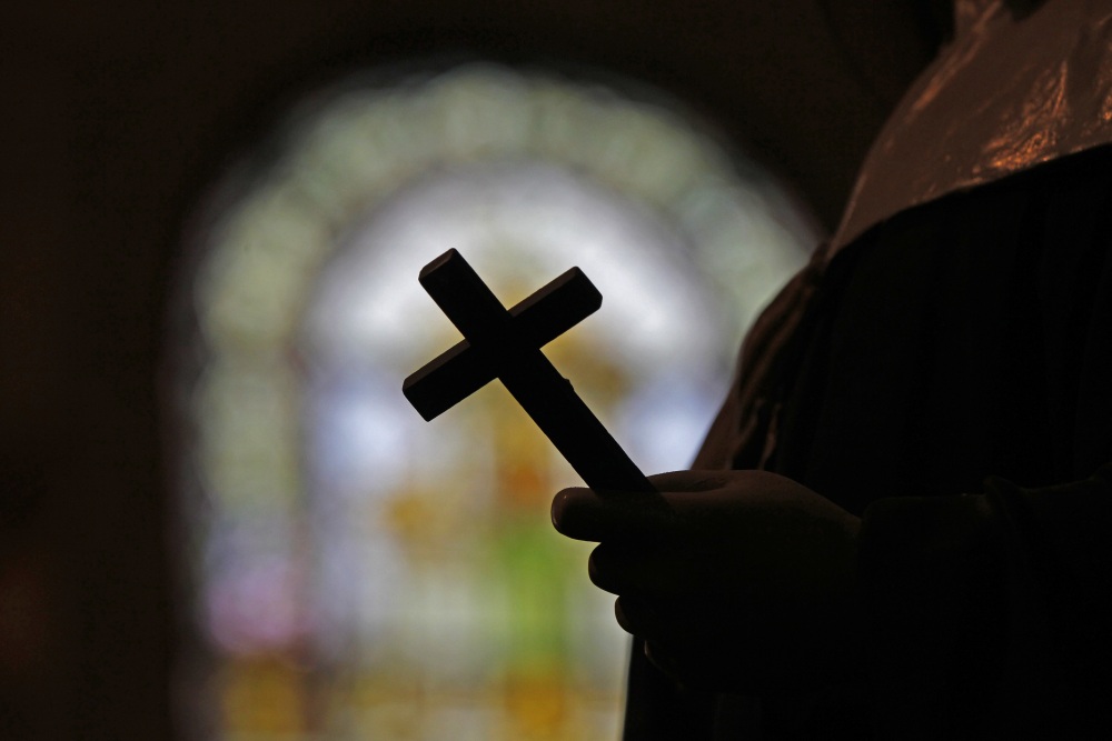 FILE - A silhouette of a crucifix and a stained glass window is seen inside a Catholic Church in New Orleans, Dec. 1, 2012. (AP)