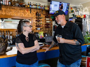 Dan Osborn, an independent candidate for U.S. Senate from Nebraska, speaks with Maranda Lee, co-owner of Lee's Crossroads Cafe, at the cafe after a town hall meeting Sept. 3, in Arapahoe, Neb.