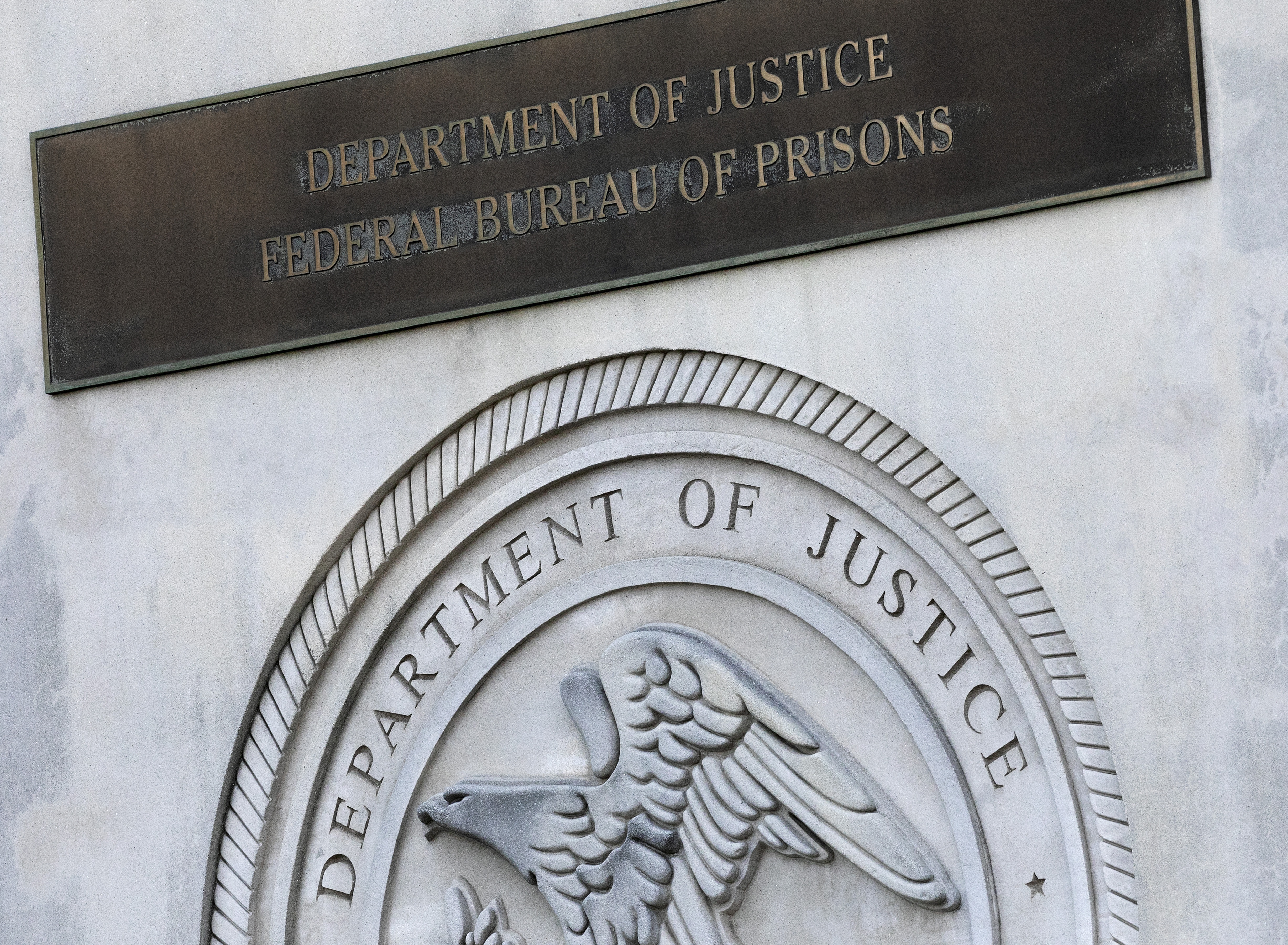 A sign for the Department of Justice Federal Bureau of Prisons is displayed in the Brooklyn borough of New York, July 6, 2020.