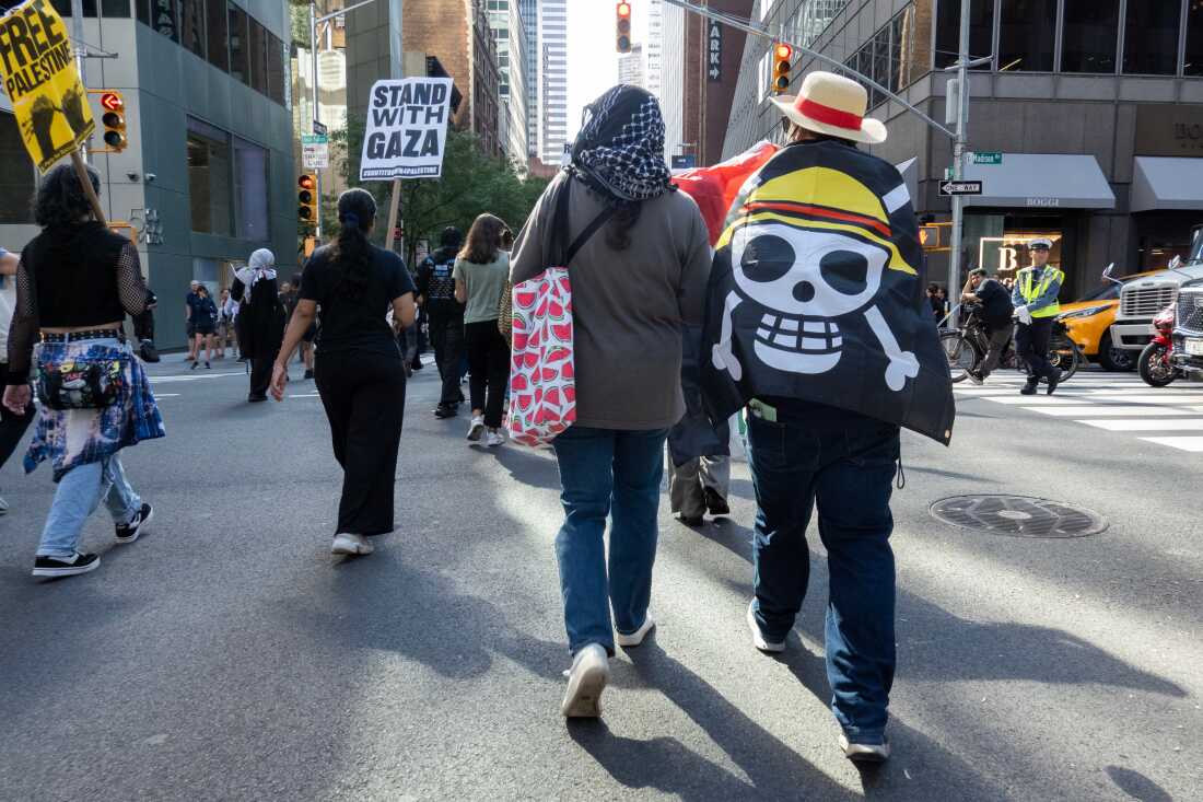 A protester outside the U.N. headquarters wears a Monkey D. Luffy pirate flag from the "One Piece" manga and anime Sept. 26, 2025, in New York.