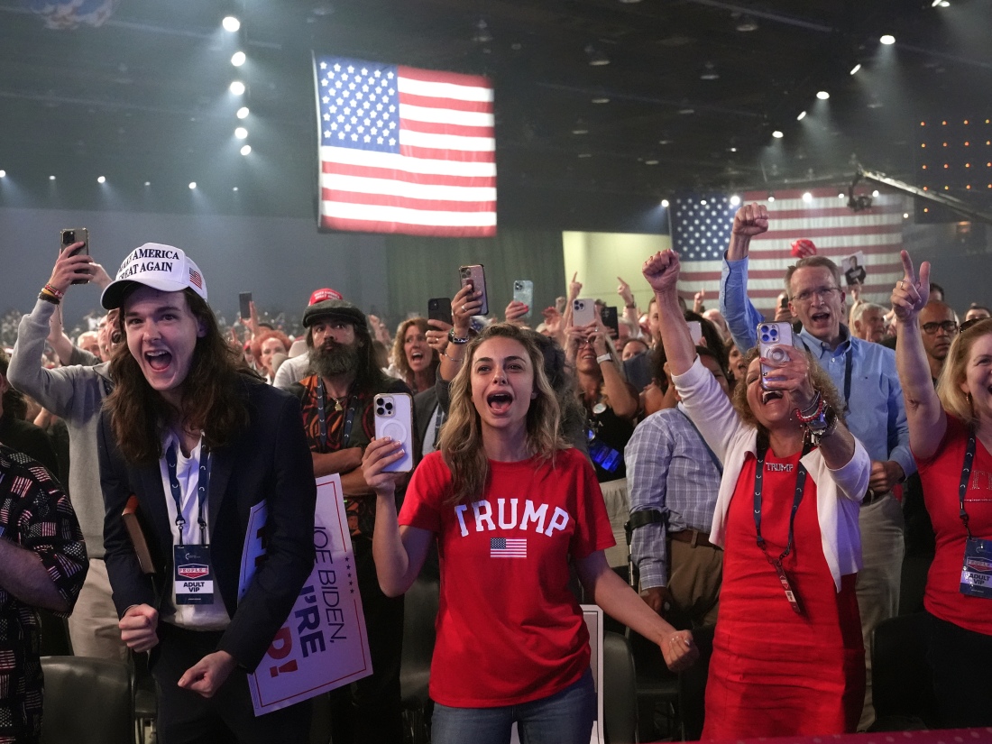 Supporters cheer as Republican presidential candidate former President Donald Trump speaks at the “People's Convention” of Turning Point Action Saturday in Detroit.