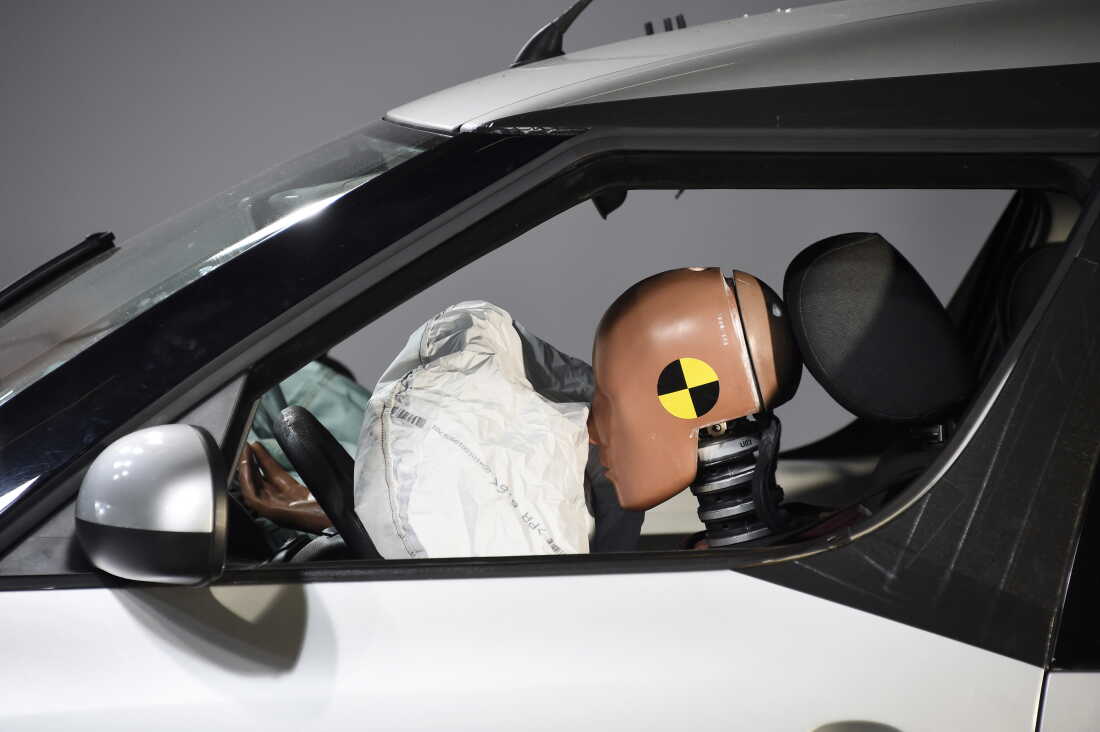 A car and its airbag are pictured after a frontal crash test with another car, without a safety belt buckled in the back seat, as part of France's Road Safety Commission's (Delegation a la Securite Routiere, DSR) campaign "Buckle your seat belt, be attached to life" on November 7, 2017 at the motor-racing track of Linas-Monthlery in Linas, south of Paris.