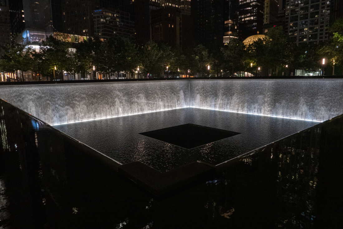This photo, taken after dark, shows one of the twin reflecting pools at the 9/11 Memorial in New York City on September 2, 2026. The square pool sits in the footprint of one of the original World Trade Center twin towers. Water falls down the inner walls of the pool.