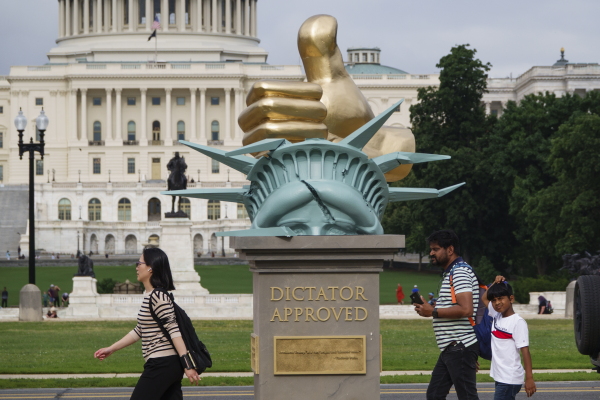 A statue titled "Dictator Approved," with quotes from various world leaders in support of Trump, is displayed on the National Mall on June 17.
