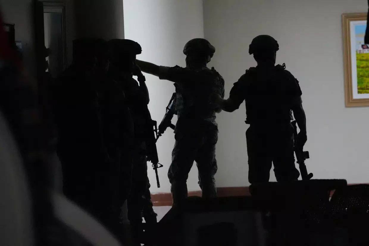 Philippine troopers exchange fire along a hallway at the Philippine Senate in Pasay, Philippines, on Wednesday.