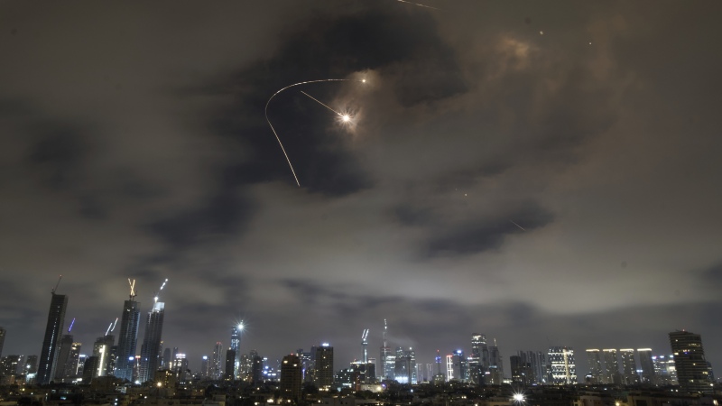 Israeli air defense system fires to intercept missiles during an Iranian attack over Tel Aviv, Israel, Saturday, June 21, 2025. 