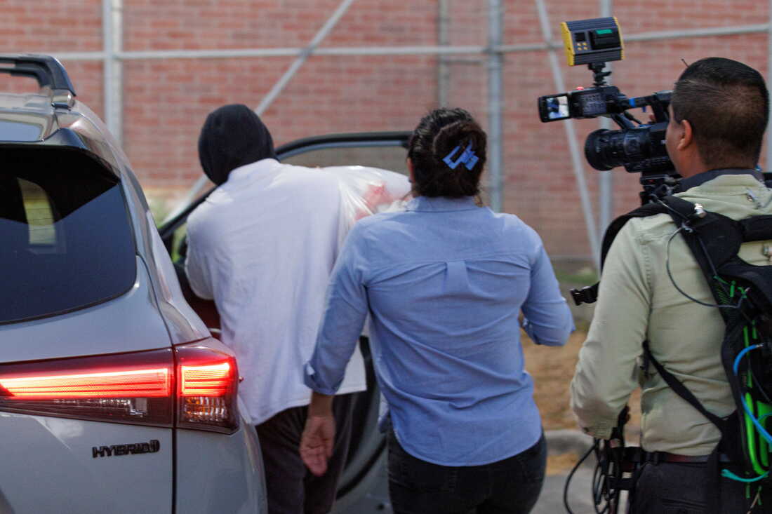 Immigration and Customs Enforcement officer Christian Castro gets into a car surrounded by news reporters moments after being released from the Carrizalez-Rucker Cameron County Detention Center in Brownsville, Texas on Aug. 27, 2026.
