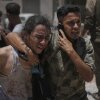 The Palestinians react after transporting the bodies of those who were killed while trying to reach aid trucks entering the north of Gaza through the passage of Zikim with Israel, to Shifa Hospital in Gaza City on Sunday.
