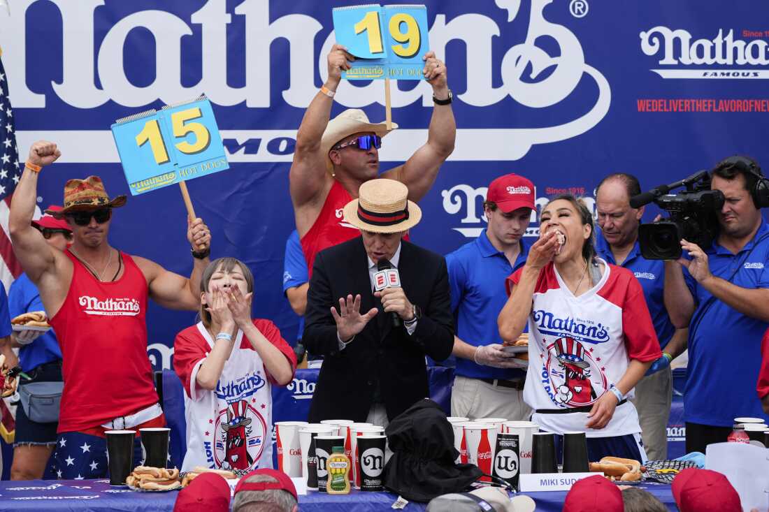 Miki Sudo (right) and Mayoi Ebihara compete in the women's division of Nathan's Famous Fourth of July hot dog eating contest, Thursday, at Coney Island in the Brooklyn borough of New York. Sudo won by eating a record 51 hot dogs.