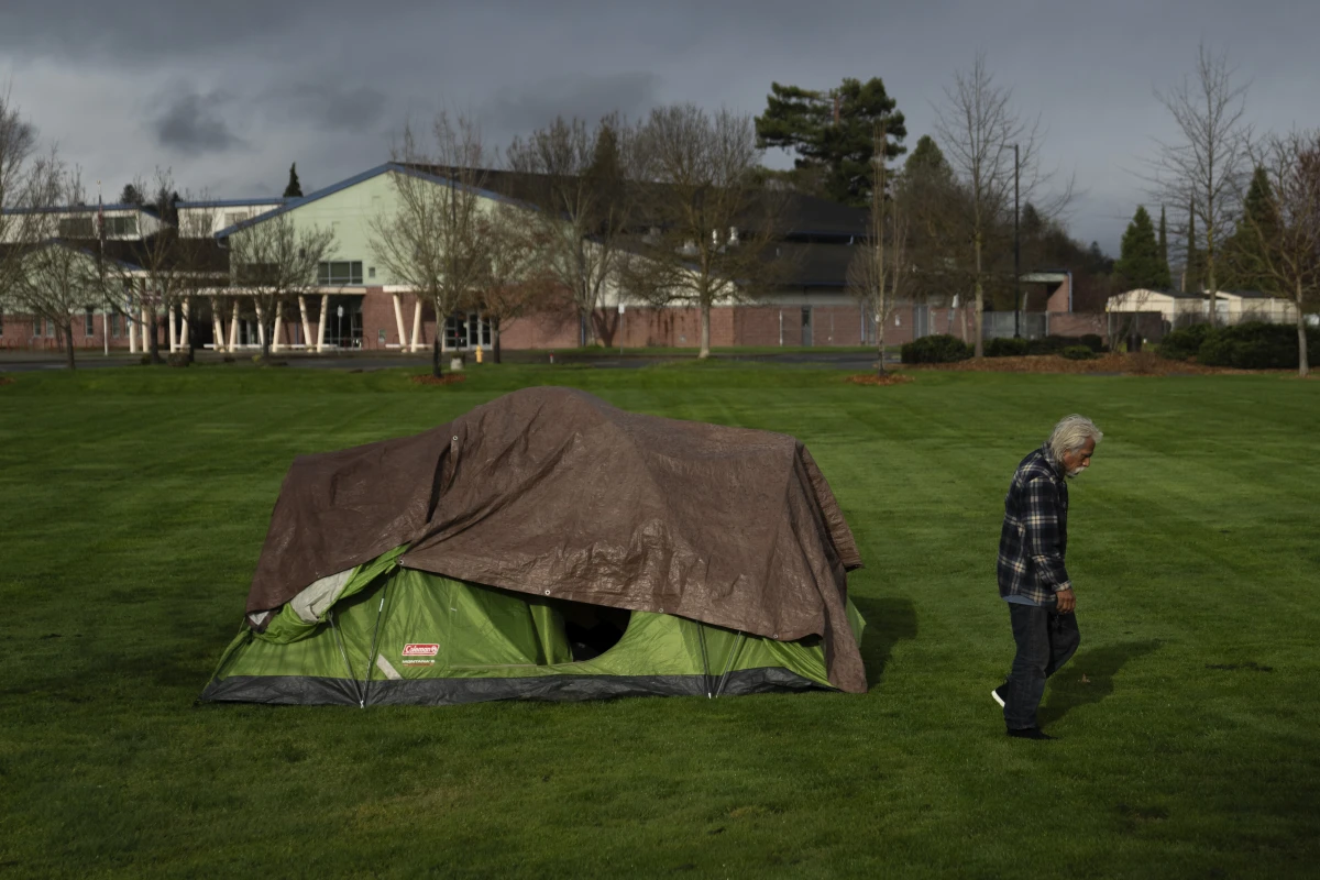A homeless person walks near an elementary school in Grants Pass, Ore., on March 23.  The rural city became the unlikely face of the nation's homelessness crisis when it asked the U.S. Supreme Court to uphold its anti-camping laws.