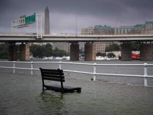 An East Potomac park bench sits underwater after a storm in July 2019. The National Park Service says flooding is common due to the man-made park's deteriorating seawall.