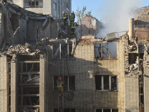 Rescuers search through the rubble of a residential building following air attack in Lviv, Ukraine, Thursday, July 30, 2026.