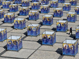 A man walks between stands displaying portraits of fallen Ukrainian fighters, which have been set up at St Sophia Square in the center of Kyiv on Sept.15, 2026, amid the Russian invasion of Ukraine.