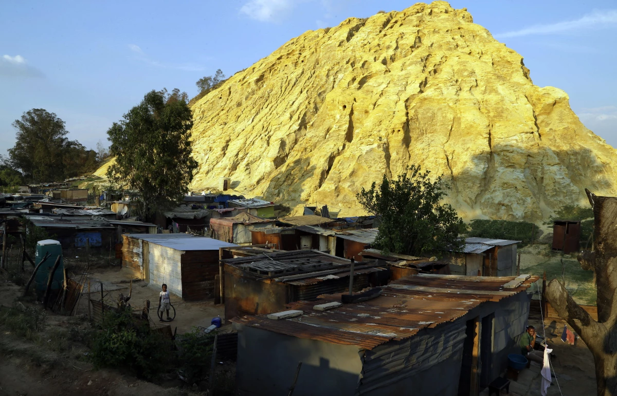 Shacks built below a gold mine dump in the Jerusalem squatter settlement, east of Johannesburg, South Africa, on Oct. 28, 2014. The squatter camp is established on the fringes of the skyscrapers of Johannesburg 'The City of Gold' on gold mine dumps bearing testimony to the crumbling dreams of millions for a better life after apartheid's end.