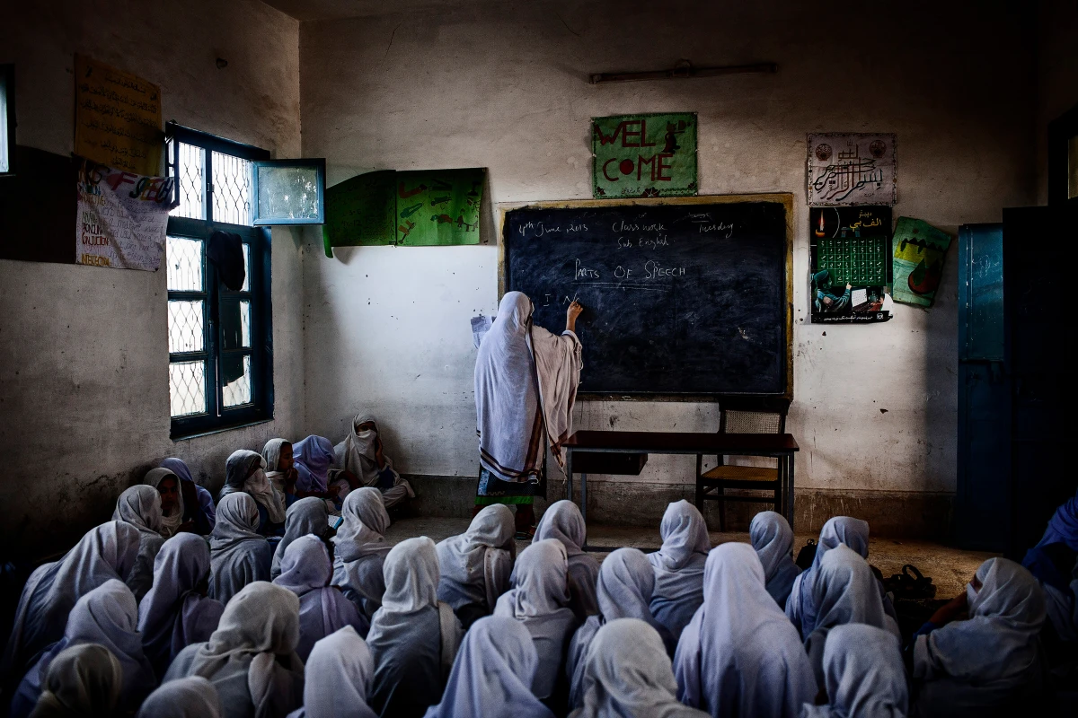 Female students attend class at their school in Pakistan, which was attacked by the Taliban on December 21, 2012 as part of a campaign to prevent girls from accessing education. This photo was taken the following year and was honored in the 'long-term project' category, Khyber Pakhtunkhwa, Pakistan. June 4, 2013.