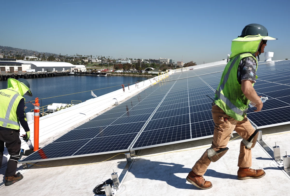 Workers install solar panels on AltaSea's research and development facility at the Port of Los Angeles in California.