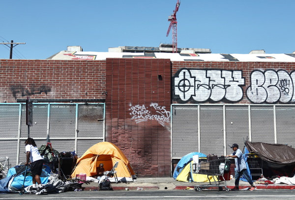 People walk by tents
