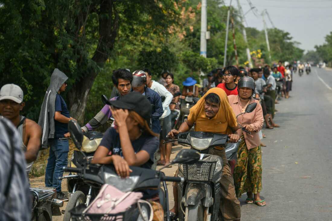Motorists wait in line at a petrol station