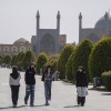 Young Iranian women walk through the area in the historic Naqsh-e Jahan Square, which is empty of crowds and tourists due to the U.S.-Israeli military campaign, in Isfahan, Iran, on March 11, 2026.