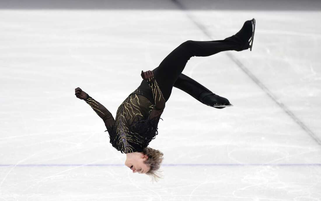 Ilia Malinin lands a backflip in his free skate in the team event on Sunday.