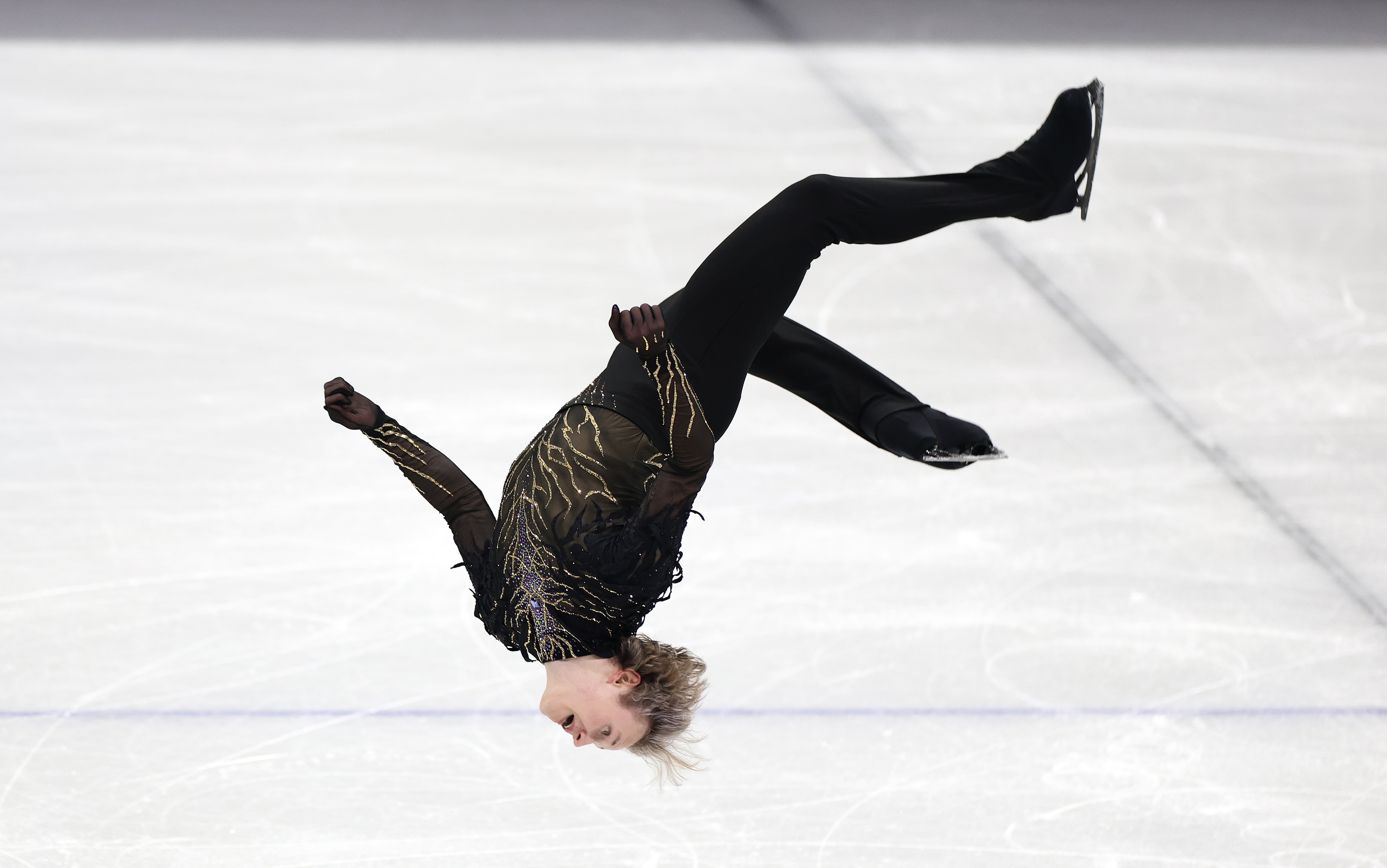 Ilia Malinin lands a backflip in his free skate in the team event on Sunday. His high score pushed Team USA to the top of the podium.