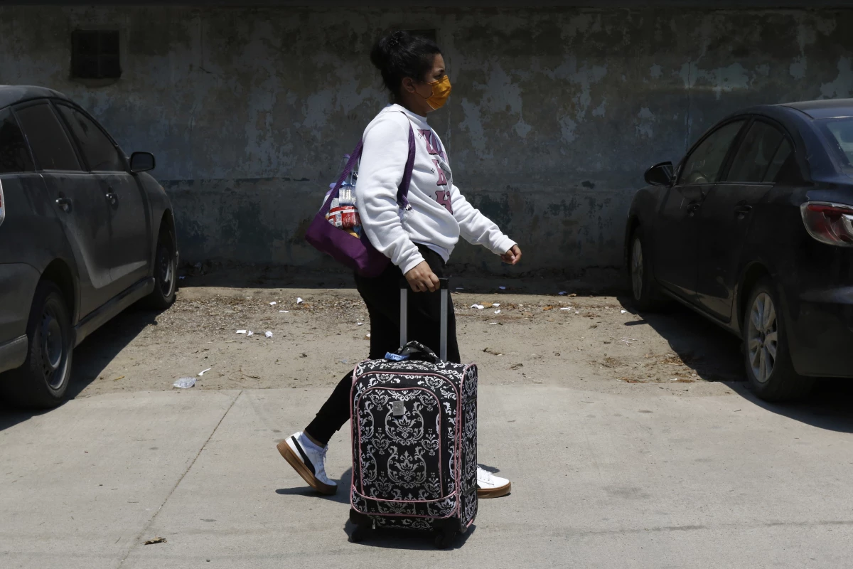 A Honduran migrant who returned voluntarily from the United States walks after arriving at Ramon Villeda Morales Airport in San Pedro Sula, Honduras on Monday.