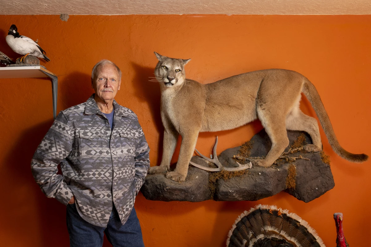 Former Wildlife Services employee Carter Niemeyer displays some of his taxidermy handiwork in his garage in Boise, Idaho.