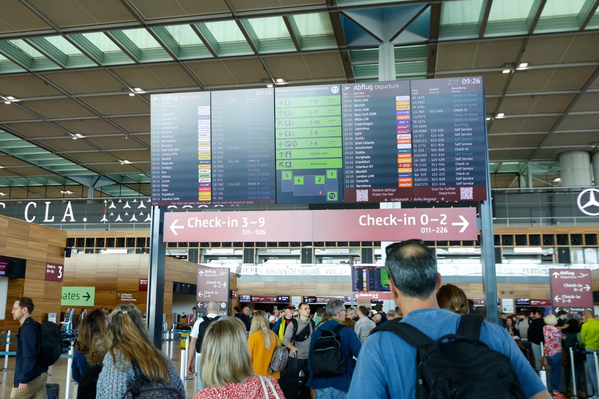 People at BER airport as a cyber attack has caused delays, in Berlin, Germany, on Saturday.