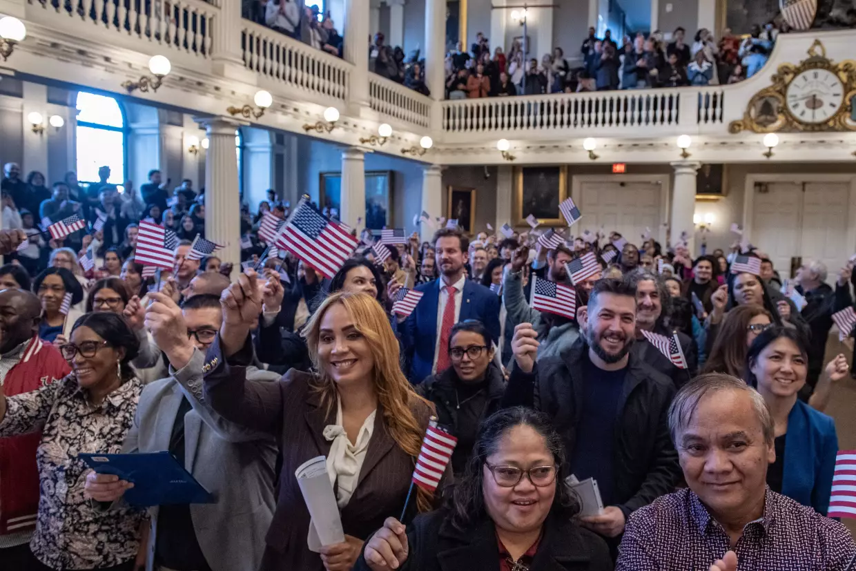 New U.S. citizens take part in a naturalization ceremony at Faneuil Hall in Boston on Jan. 8.